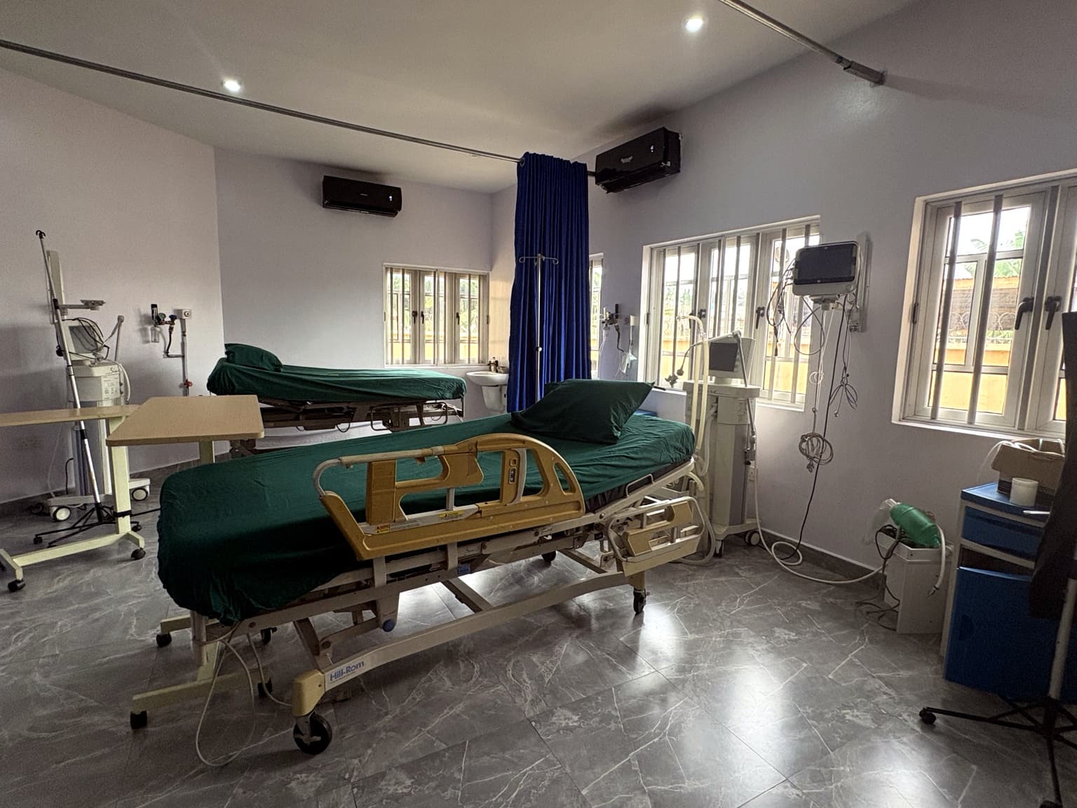 Patient ward at Banby Specialist Hospital in Ibadan, with two beds, a patient monitor and piped oxygen at the bedside