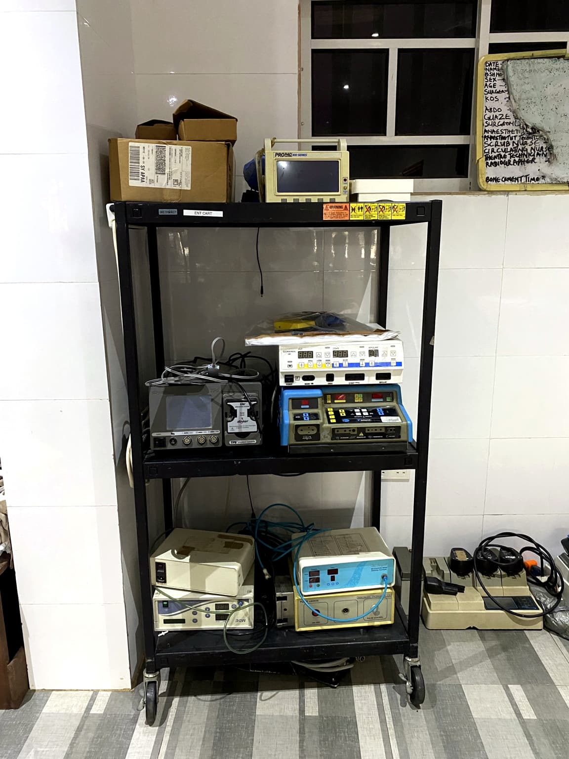 Equipment cart at Banby Specialist Hospital in Ibadan, holding a patient monitor, electrosurgical units and powered surgical consoles